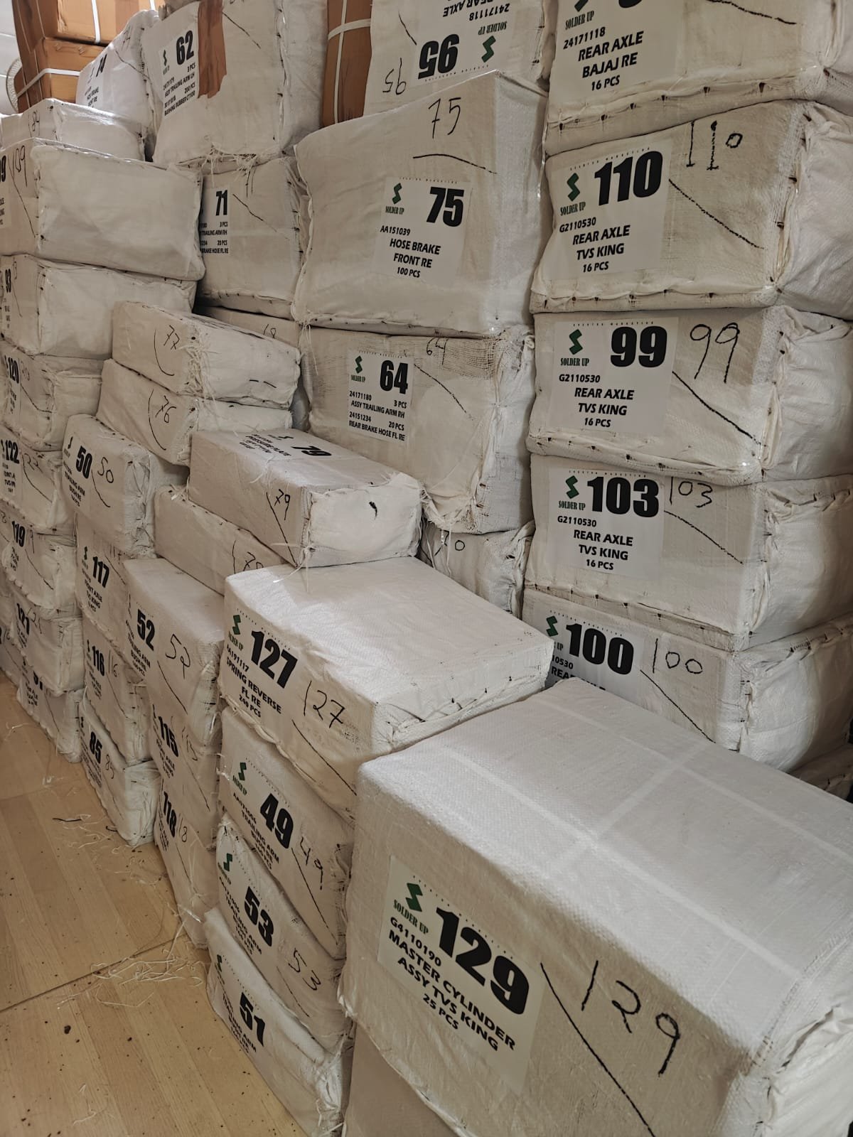 Solder Up labelled spare-parts cartons stacked and packed for dispatch
